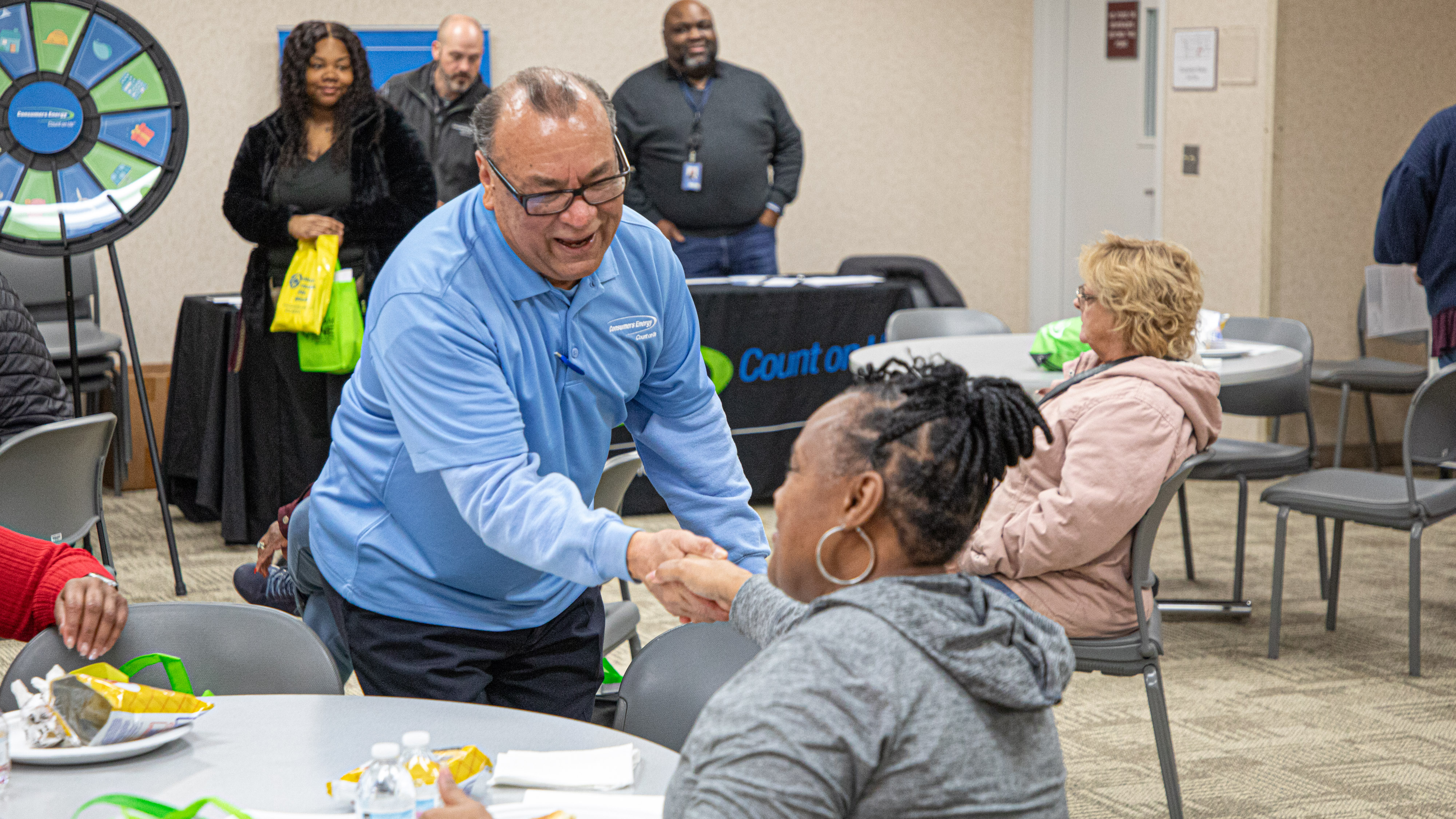 Consumers Energy employees with customers at an outreach event